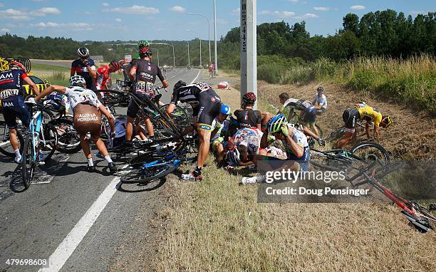 Riders get to their feet and assess damage to bikes following a crash near Brabant Wallon during stage three of the 2015 Tour de France, a 159.5 km...
