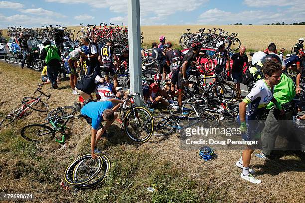 Riders get to their feet and assess damage to bikes following a crash near Brabant Wallon during stage three of the 2015 Tour de France, a 159.5 km...