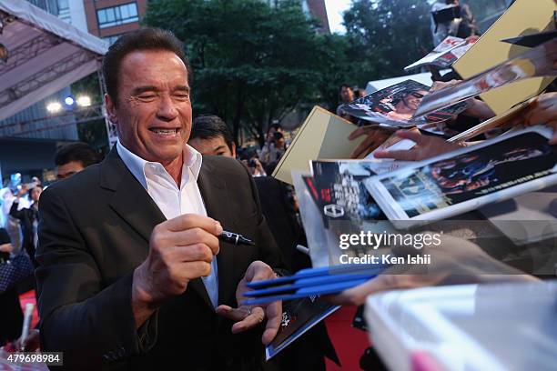 Arnold Schwarzenegger signs autographs for fans during the Tokyo Premiere of 'Terminator Genisys' at the Roppongi Hills Arena on July 6, 2015 in...