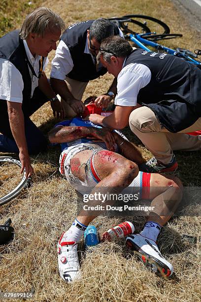 William Bonnet of France riding for FDJ is attended to after being involved in a crash with 65km remaining in stage three of the 2015 Tour de France...