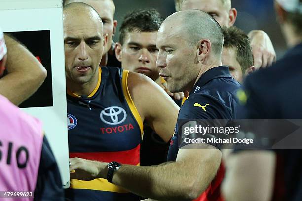 Crows coach Brenton Sanderson talks to the players at three quarter time during the round one AFL match between the Geelong Cats and the Adelaide...