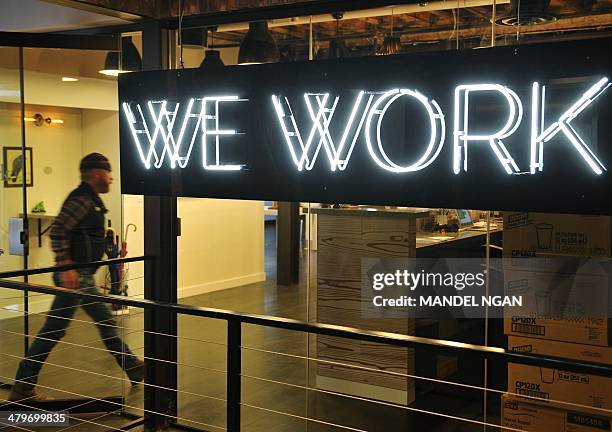 Man enter the doors of the "WeWork" co-operative co-working space on March 13, 2013 in Washington, DC. In a large warehouse-type office in...