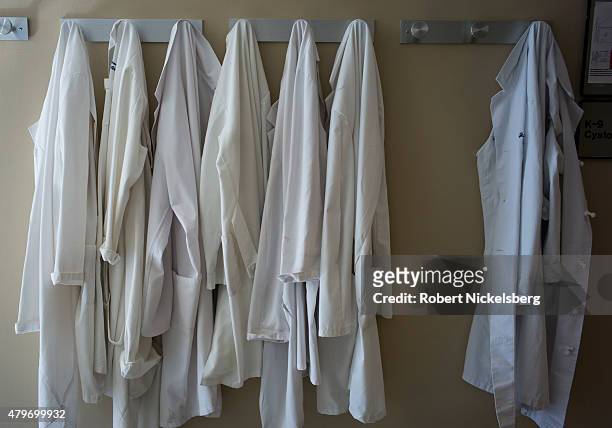 White doctor's jackets hang on a wall rack of the New York-Presbyterian Weill Cornell Medical Center hospital in the Manhattan borough of New York.