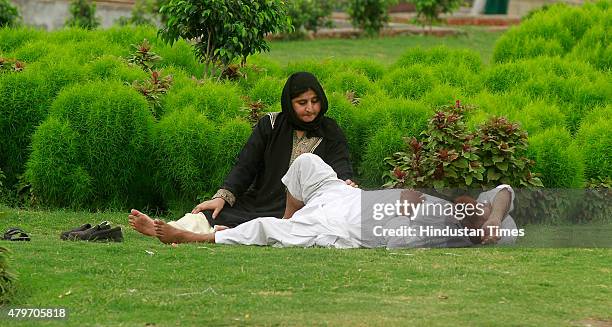 Muslim couple enjoys pleasant weather after first monsoon showers hit the capital on July 6, 2015 in New Delhi, India. The city received heavy rains...