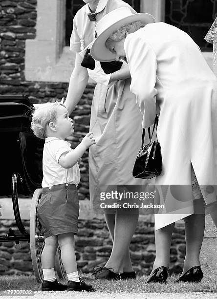 Prince George of Cambridge talks to Queen Elizabeth II as they leave the Church of St Mary Magdalene on the Sandringham Estate for the Christening of...