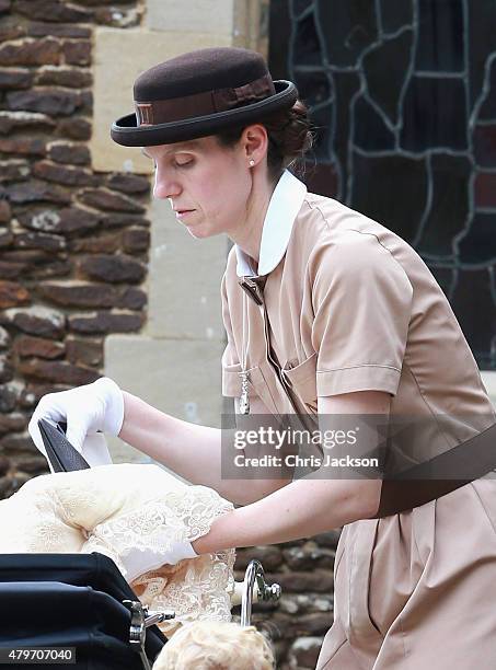 Prince George's nanny, Maria Teresa Turrion Borrallo helps secure Princess Charlotte of Cambridge in her pram as she leaves the Church of St Mary...