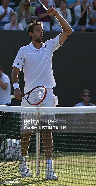 Croatia's Marin Cilic celenbrates beating US player Denis Kudla during their men's singles fourth round match on day seven of the 2015 Wimbledon...