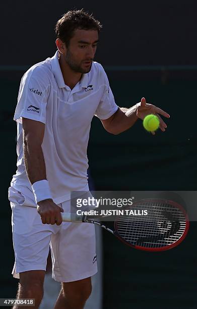 Croatia's Marin Cilic returns to US player Denis Kudla during their men's singles fourth round match on day seven of the 2015 Wimbledon Championships...