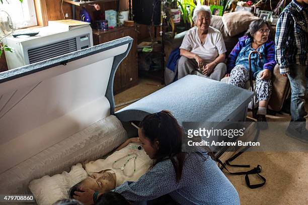 The body of Nancy Beaver, who died in Anchorage in hospice care after a series of strokes, is viewed by villagers on July 5, 2015 in Newtok, Alaska....