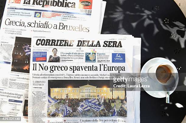 Major Italian newspapers are seen on a table outside a cafe the day after Greece's austerity referendum which dominates the Italian front pages...