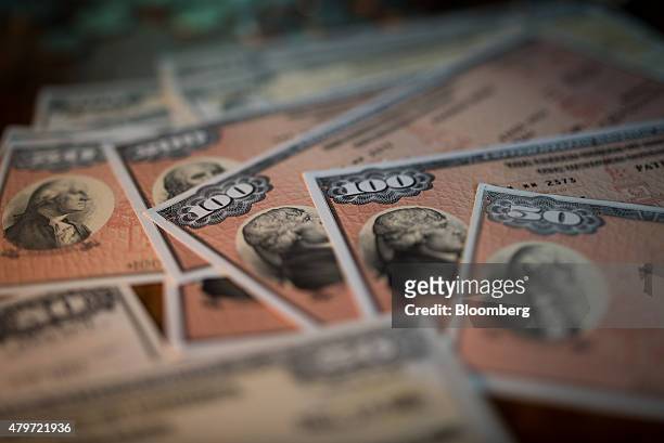 Savings bonds are seen in this arranged photograph taken with a tilt-shift lens to illustrate the theme of risk in Oradell, New Jersey, U.S., on...