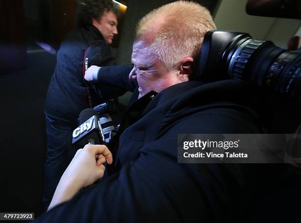 Mayor Rob Ford leaves the executive meeting and bulldozes through the media at City Hall. Toronto, March 19, 2014.