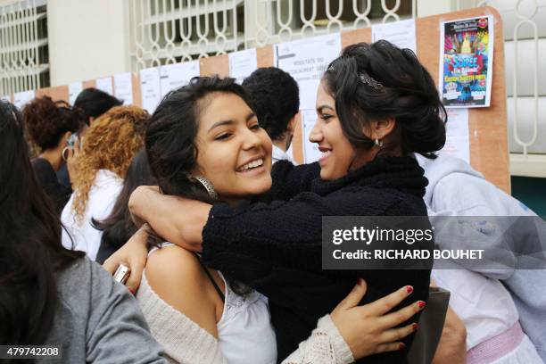 Students react after viewing the results of the baccalaureat exam on July 7, 2015 at the Leconte de Lisle high school in Saint-Denis-de-la-Reunion,...