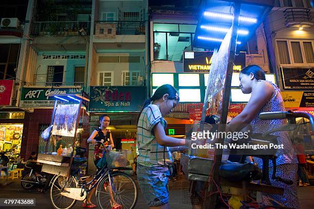 Street vendors cook and sell dried seafood from their bicycle carts in District 1 in Ho Chi Minh City, Vietnam on March 154, 2015.