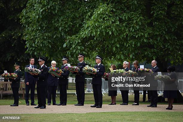 Ambulance, Fire and Police representatives are joined by British Prime Minister David Cameron and London Mayor Boris Johnson during a ceremony at the...