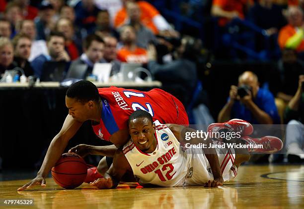 Sam Thompson of the Ohio State Buckeyes and Dyshawn Pierre of the Dayton Flyers dive for a loose ball during the second round of the 2014 NCAA Men's...