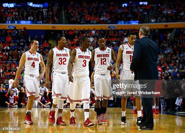 The Ohio State Buckeyes walk to the bench during the second round of the 2014 NCAA Men's Basketball Tournament against the Dayton Flyers at the First...