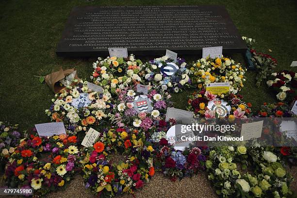 Flowers are laid during a ceremony at the memorial to the victims of the July 7, 2005 London bombings, in Hyde Park on July 7, 2015 in London,...
