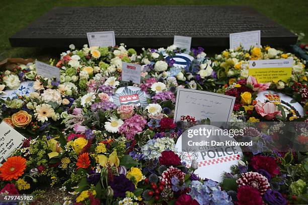 Flowers are laid during a ceremony at the memorial to the victims of the July 7, 2005 London bombings, in Hyde Park on July 7, 2015 in London,...