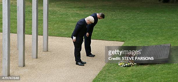 British Prime Minister David Cameron and London Mayor Boris Johnson lay wreaths during a wreath laying ceremony in London's Hyde Park on July 7 in...
