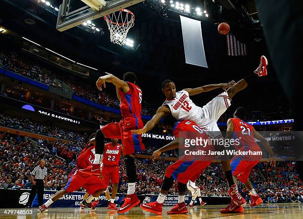 Sam Thompson of the Ohio State Buckeyes gets tangled with Khari Price of the Dayton Flyers under the basket during the second round of the 2014 NCAA...