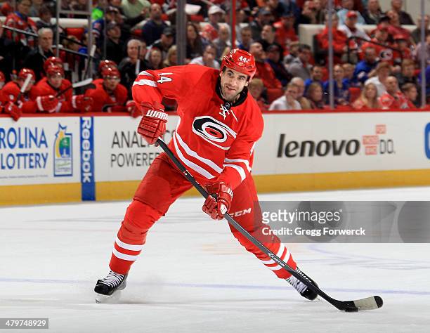Jay Harrison of the Carolina Hurricanes looks to pass the puck during their NHL game against the New York Rangers at PNC Arena on March 11, 2014 in...