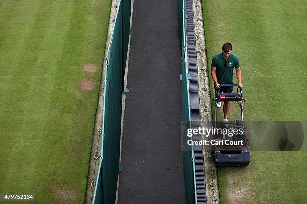 Member of ground mows a court ahead of play on day 8 of the Wimbledon Lawn Tennis Championships at the All England Lawn Tennis and Croquet Club on...