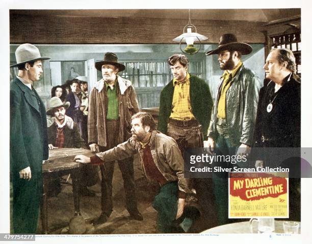 Lobby card for John Ford's 1946 western 'My Darling Clementine', starring Henry Fonda . Left to right: Fonda, Walter Brennan, Grant Withers , John...