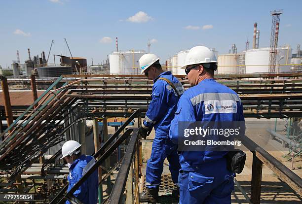 Workers exit the rail terminal after filling tank wagons with oil and petroleum ahead of shipping at the Atyrau oil refinery, operated by KazMunaiGas...