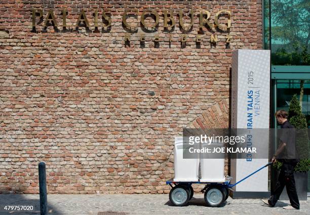 Worker brings compact air conditioners to the Palais Coburg Hotel, where the Iran nuclear talks meetings are being held, in Vienna, Austria on July...