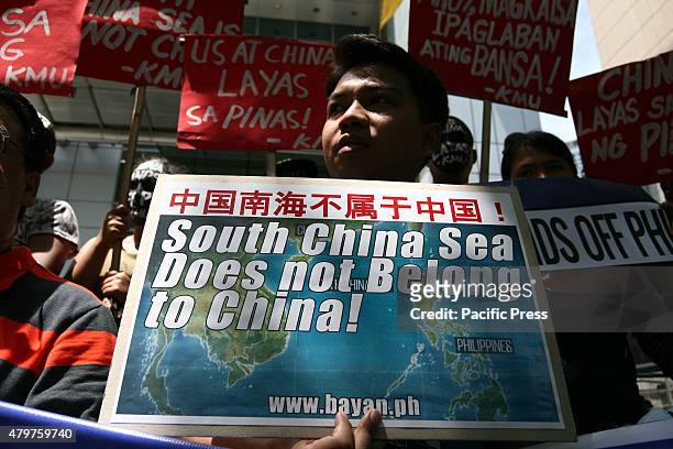 Protesters holding posters against China's incursions in the South China Sea. Labor group Kilusang Mayo Uno lead a protest march to the Chinese...