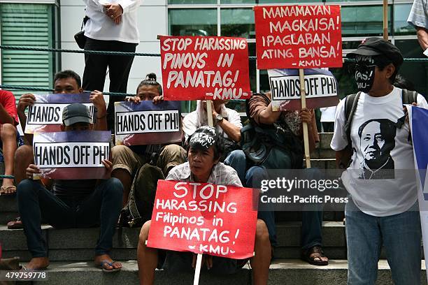 Protesters in front of the Chinese embassy hold placards against China's incursions in the South China Sea. Labor group Kilusang Mayo Uno lead a...