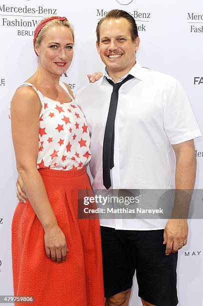 Eva Mona Rodekirchen and Bjoern Geske attend the Lena Hoschek show during the Mercedes-Benz Fashion Week Berlin Spring/Summer 2016 at Brandenburg...