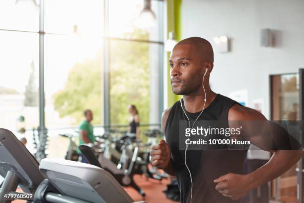 man in a gym running on a treadmill. - focus on sport 2013 stockfoto's en -beelden