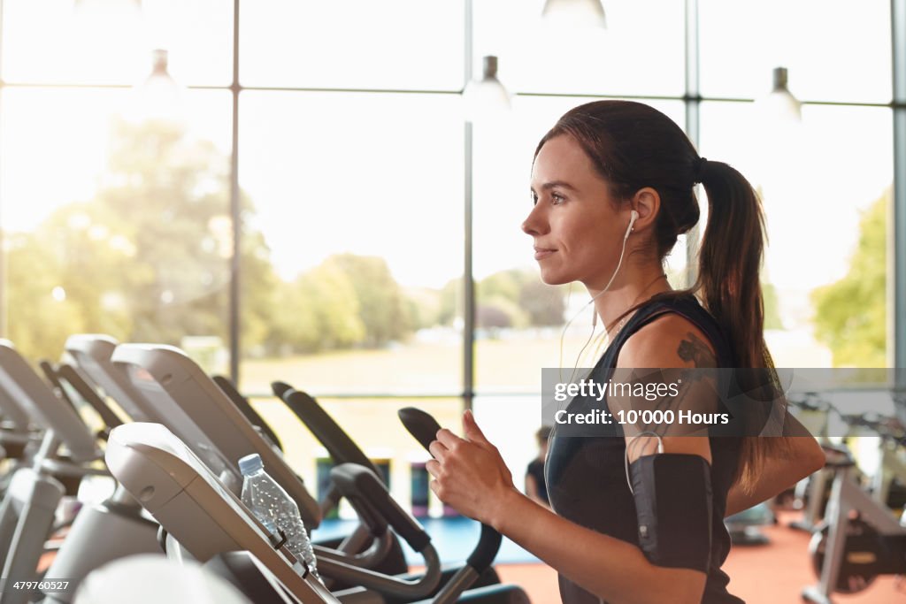 Woman in a gym on a running machine