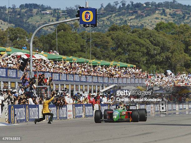 Nelson Piquet of Brazil driving the Benetton Formula Benetton B190 Ford V8 takes the chequred flag to win the Foster's Australian Grand Prix on 4th...