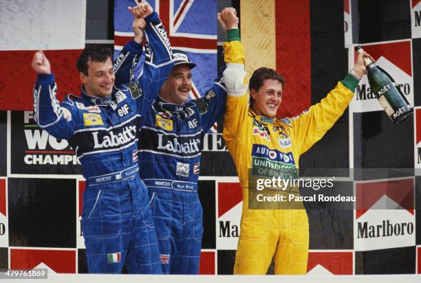 Nigel Mansell of Great Britain , driver of the Canon Williams Renault Williams FW14B Renault RS3C/RS4 V10 celebrates winning with 2nd placed team...