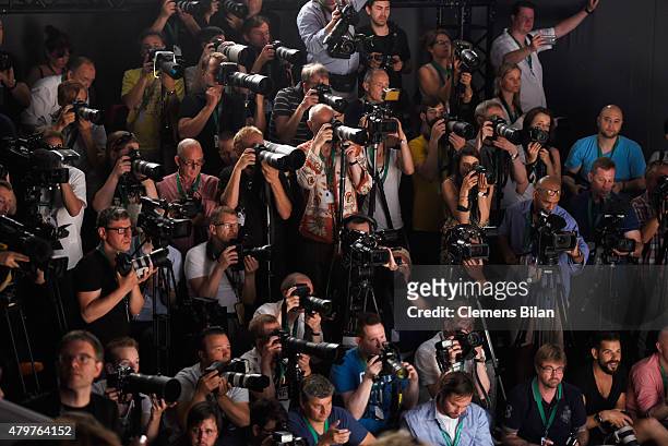 Photographers shoot the runway at the Lena Hoschek show during the Mercedes-Benz Fashion Week Berlin Spring/Summer 2016 at Brandenburg Gate on July...