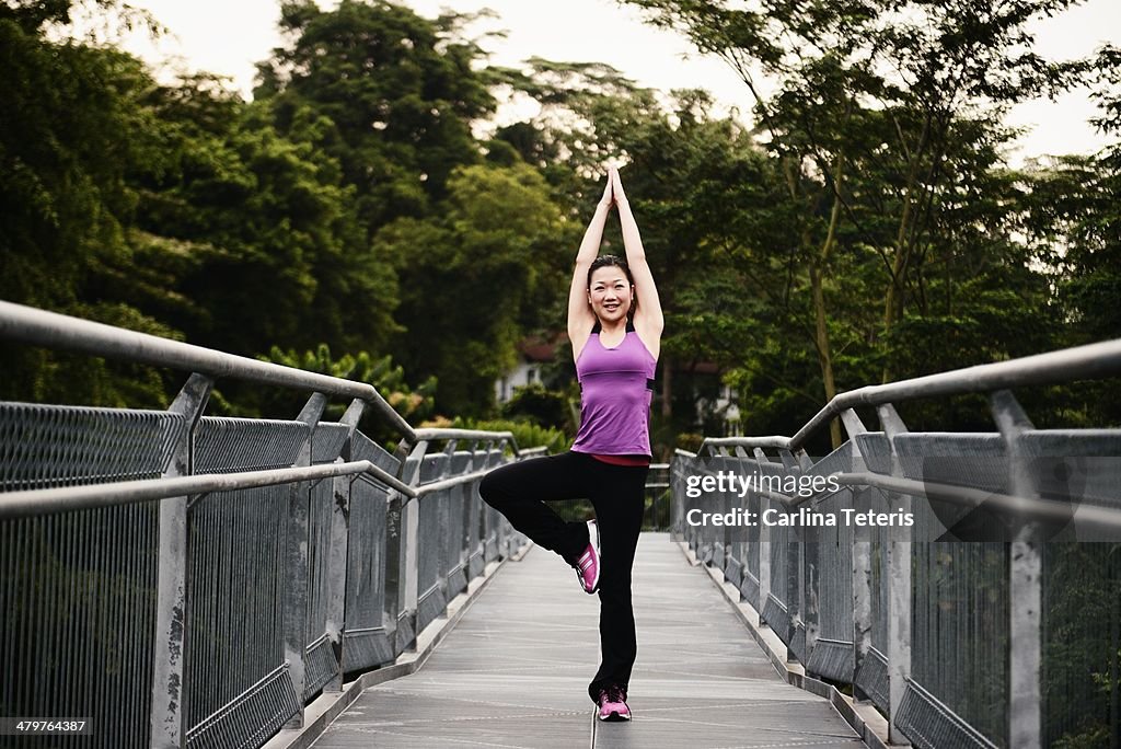 Chinese woman doing a yoga pose in workout gear