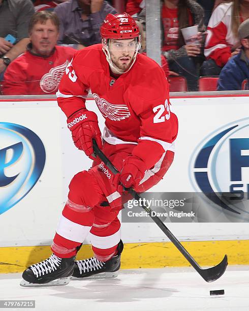 Brian Lashoff of the Detroit Red Wings turns up ice with the puck against the Edmonton Oilers during an NHL game on March 14, 2014 at Joe Louis Arena...