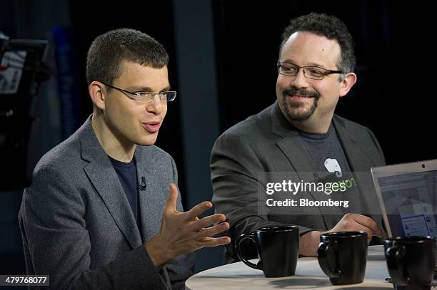 Max Levchin, co-founder of PayPal Inc. And chairman of Kaggle Inc., left, speaks as Phil Libin, chief executive officer of Evernote Corp., listens...