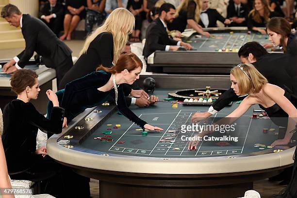 Julianne Moore with Kristen Stewart and Lily-Rose Depp, plays roulette during Karl Lagerfeld's casino presentation at the Grand Palais, Chanel Haute...
