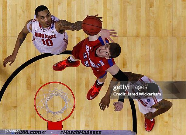 LaQuinton Ross of the Ohio State Buckeyes reaches for a rebound in the final seconds of the second half in front of Matt Kavanaugh of the Dayton...