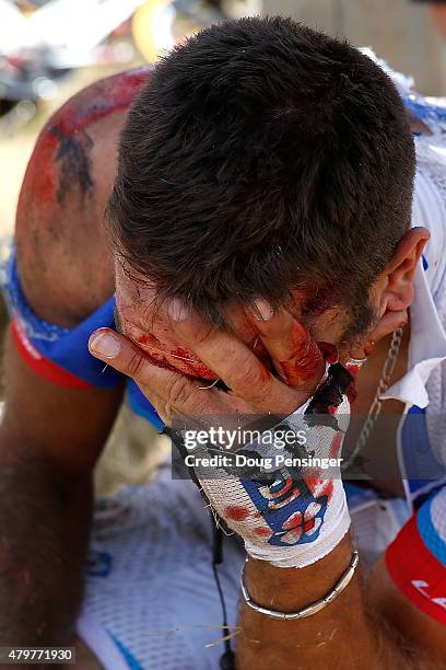 William Bonnet of France riding for FDJ is attended to after being involved in a crash with 65km remaining in stage three of the 2015 Tour de France...