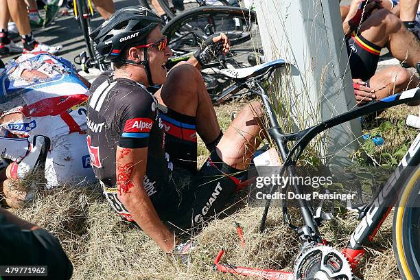 Ramon Sinkeldam of the Netherlands riding for Giant-Alpecin tries to pick himself up from the ground after being involved in a crash 65km from the...