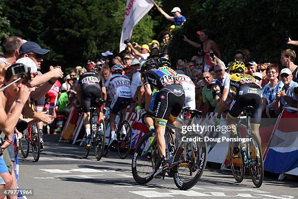 Riders are encouraged by fans on the climb of the Mur de Huy as they near the finish of stage three of the 2015 Tour de France from Anvers to Huy on...