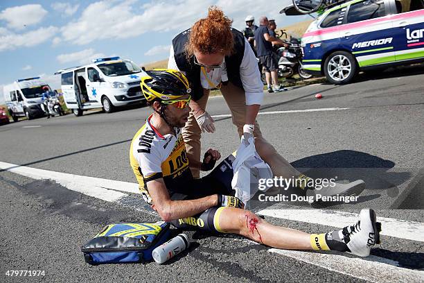 Laurens Ten Dam of the Netherlands riding for Team LottoNL-Jumbo is attended to by medial personel after being involved in a crash with 65km...