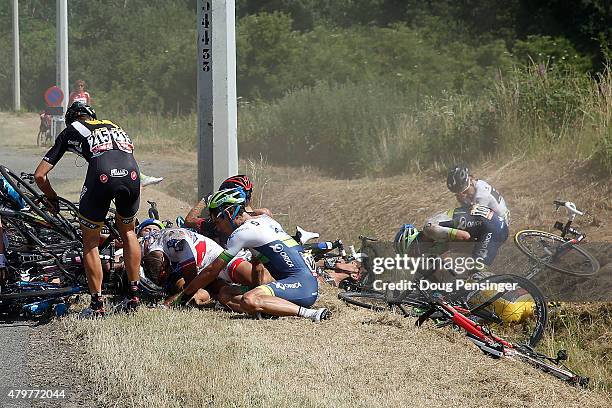 Riders litter the side of the road including Fabian Cancellara of Switzerland riding for Trek Factory Racing in the overall race leader yellow jersey...