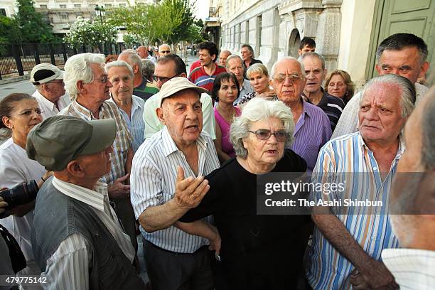 Pensioners queue up to collect their pensions outside a National Bank of Greece branch in Kotzia Square on July 7, 2015 in Athens, Greece. Greek...