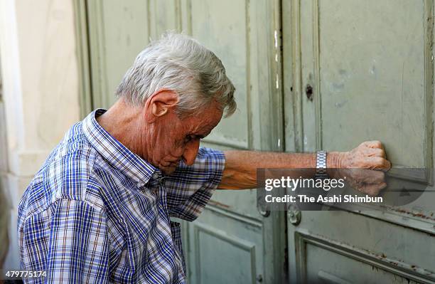 Pensioners queue up to collect their pensions outside a National Bank of Greece branch in Kotzia Square on July 7, 2015 in Athens, Greece. Greek...